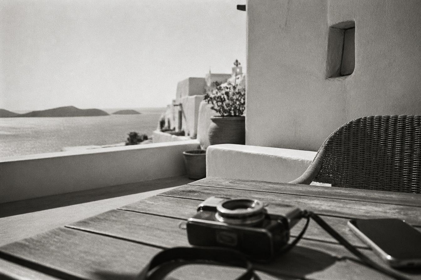 Vintage camera on a sunlit Mediterranean terrace overlooking the sea